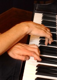 Bruce Hornsby playing the piano; photo by Kathy Keeney