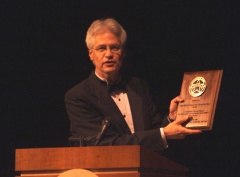 Jim holds a Legends plaque
